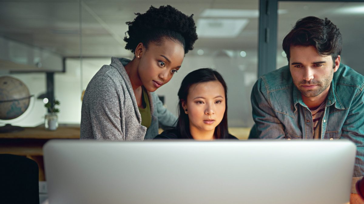 Diverse, team and office for computer, collaborate and designers. Brainstorming, pc and technology or modern, group and ideas for workspace, colleagues and mock up on internet, online or research.